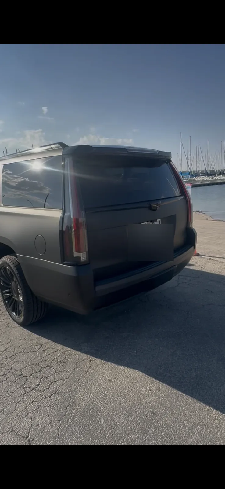 Cadillac Escalade rear three-quarter exterior with license plate obscured